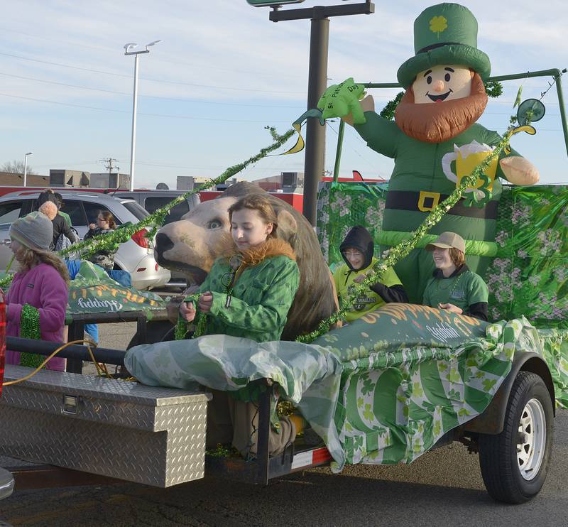 The An inflatable Leprechaun aboard the Lions Club float,waves to the crowd along Main St in Marseilles Saturday during the annual St Patrick's Day Parade.