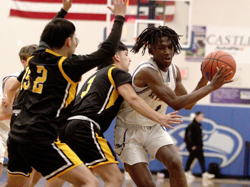 Johnsburg’s  Jarrel Albea, right, moves the ball against Harvard in varsity boys basketball at Johnsburg Saturday.