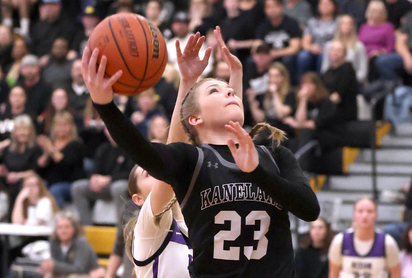 Kaneland's Kendra Brown gets a layup in front of Dixon’s Morgan Hargrave Thursday, Feb. 22, 2024, during their Class 3A sectional final game at Sycamore High School.
