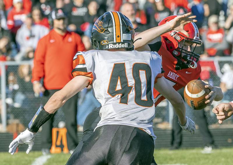 Amboy’s Tanner Welch avoids a tackle by Milledgeville’s Benny Mickelson Saturday, Nov. 15, 2025, in the 8-man football semifinal.