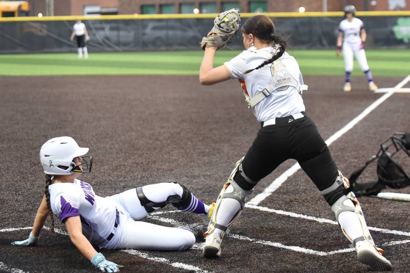 Wilmington's Madisyn Rossow, left, slides in for a run as Bishop McNamara's Abbie Bysor fields a late throw during the Class 2A Seneca Regional semifinals Wednesday, May 20, 2026.