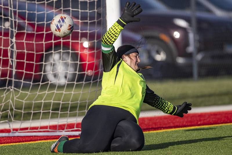 Ottawa High School kicks a ball past LaSalle-Peru High School goalie Lillie Higgins during the match on April 10, 2025 at the LaSalle-Peru Sports Complex.