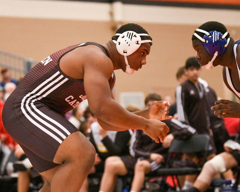 Dillan Johnson, left, of Joliet Catholic Academy keeps his eyes on Mt. Prospect during the match up in the 220 weight class on Friday Dec. 30th during The Don Flavin wrestling Invite held at DeKalb High School.