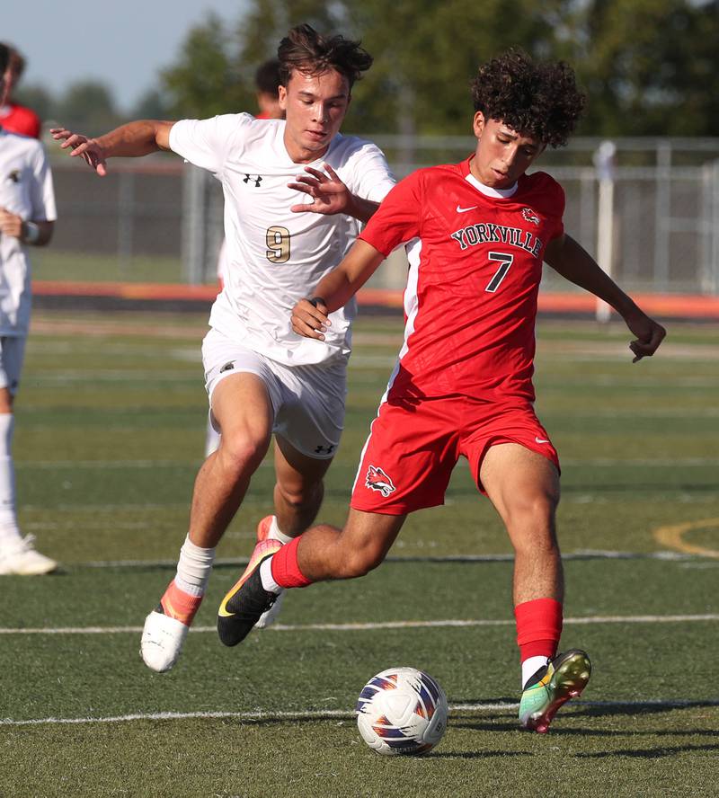 Yorkville's Oliver Villa tries to pull away from Sycamore's Felix Arends Thursday, Aug. 28, 2025, during their game in the Barb Cup tournament at DeKalb High School.