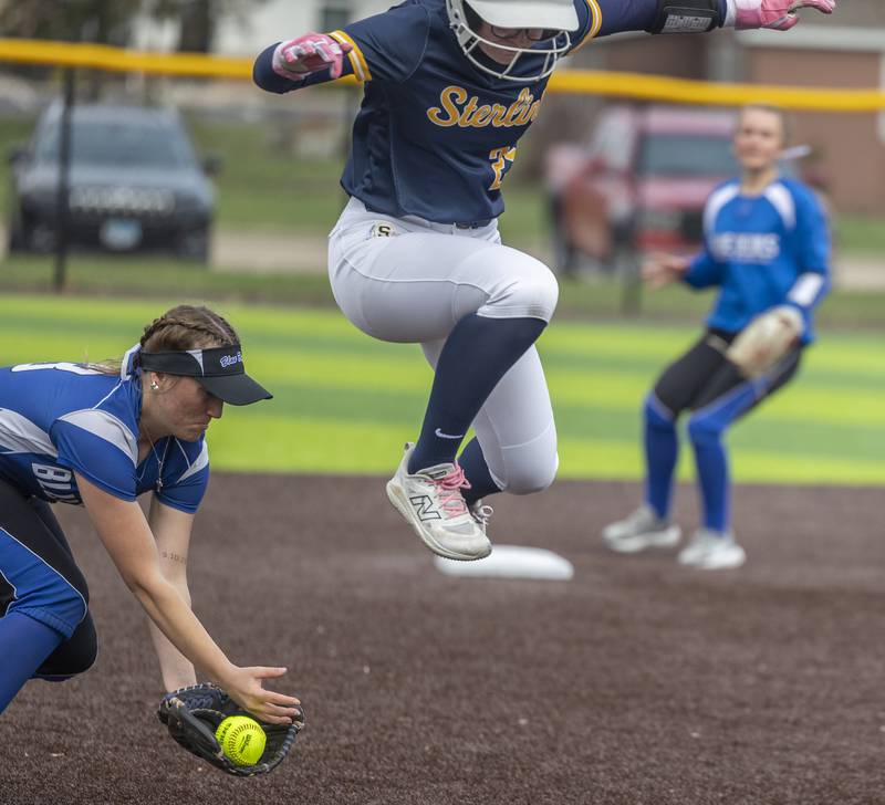 Sterling’s Kennedy Tate leaps over a grounder played by Quincy’s Ava Geisendorfer Tuesday, March 31, 2026.