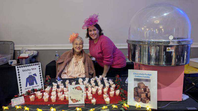Annette Dillard of Romeville and Amanda Lovecky of Joliet behind their Sticky Stix table at the Shorewood HUGS annual chocolate ball on Saturday, February 1, 2025, in Joliet.