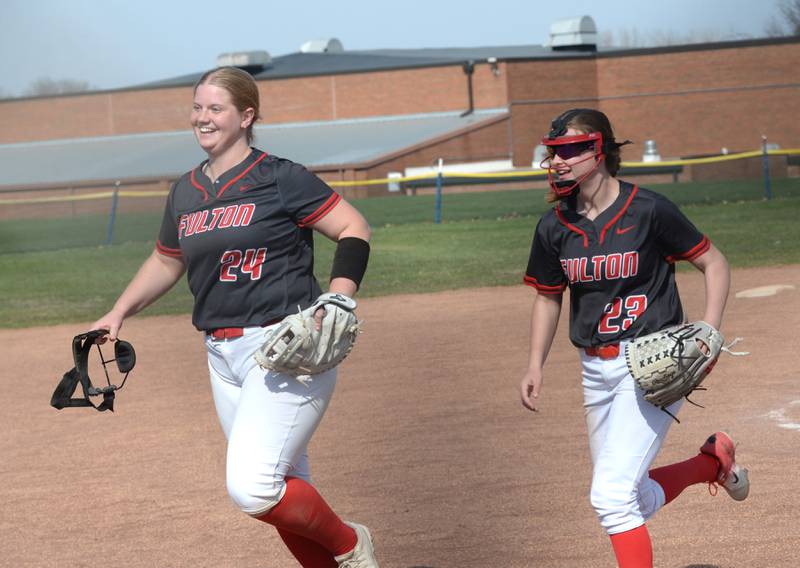 Fulton's Kylie Smither and Wrenn Coffey smile as they run to their dugout after an out against Milledgeville at the Pearl City Tournament on Saturday, April 12, 2025.