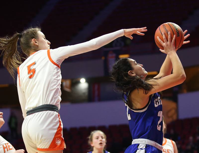 Geneva's Leah Palmer runs inside of Hersey's Katy Eidle to score a basket during the Class 4A third place game on Friday, March 3, 2023 at CEFCU Arena in Normal.