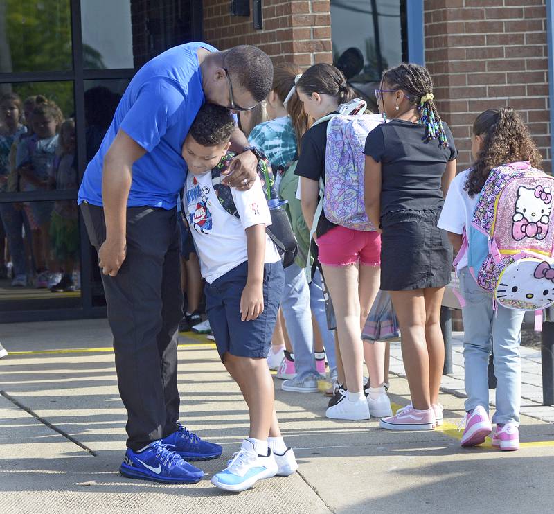 Jeremy Barnett hugs his son Jett as he prepares to enter Centennial School in Streator for the first day of school Wednesday.