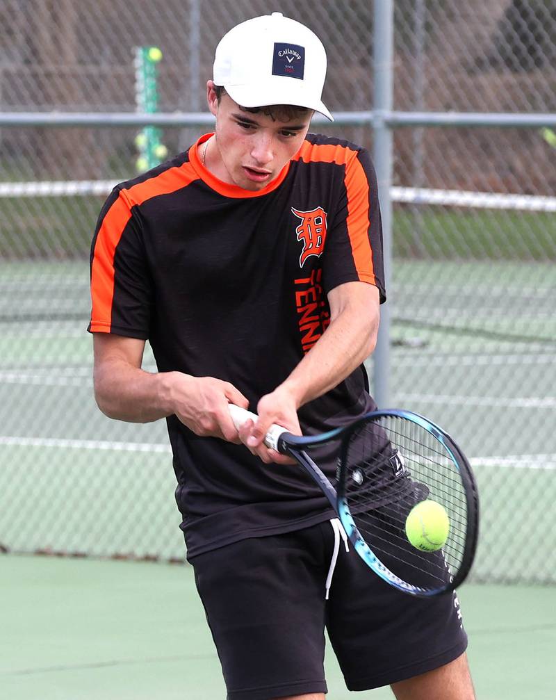 DeKalb number one doubles player Ryan Lottes hits a backhand Thursday, April 24, 2025, during their match at Sycamore High School.