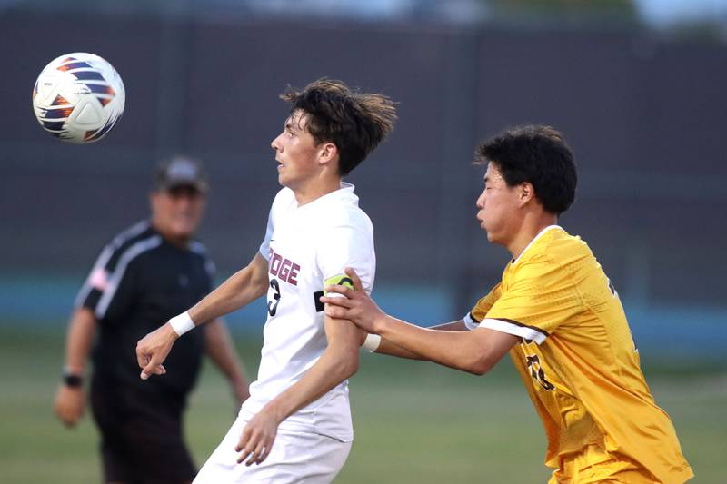 Jacobs’  Elnur Kaziev, right, races Prairie Ridge’s Trenton Pavoris for the ball in varsity soccer at Jacobs High School in Algonquin on Thursday, Sept. 18, 2025.