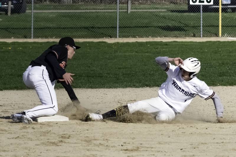Sterling's Daylen Stage slides safely into second base as the throw gets away from United Township during their Western Big 6 game Tuesday at Gartner Park.