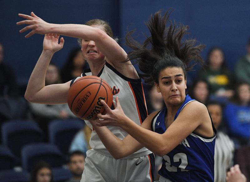 John Starks/jstarks@dailyherald.com
Geneva’s Leah Palmer and Naperville North’s Peyton Fenner battle in the semifinal game of the Morton College girls basketball tournament in Cicero on Thursday, December 29, 2022.