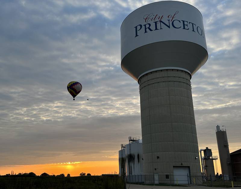 A hot air balloon passes by the City of Princeton water tower on Sunday, Sept. 10, 2023 for the 52nd annual Homestead Festival.