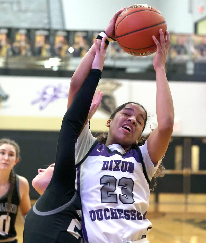 Dixon’s Ahmyrie McGowan grabs a rebound over Kaneland's Kendra Brown Thursday, Feb. 22, 2024, during their Class 3A sectional final game at Sycamore High School.