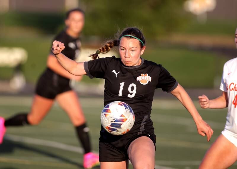 Wheaton Warrenville South’s Kate Gronlund keeps her eye on the ball during a game against St. Charles East in Wheaton on Tuesday, April 18, 2023.