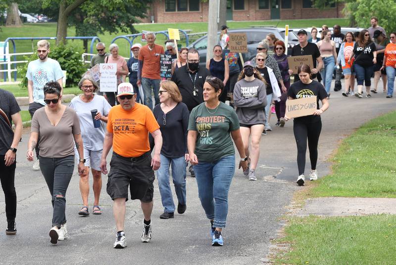 Protesters march in Hopkins Park in DeKalb Saturday, June 11, 2022, during a March For Our Lives event. The March For Our Lives initiative advocates for, among other things, an end to gun violence, updated gun control legislation and policy targeting gun lobbyists.