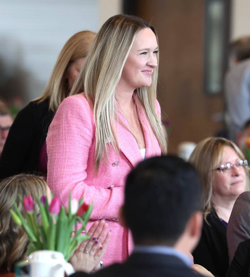 Heather Martines comes up to accept the Spirit of Small Business Award on behalf of Sycamore Orthodontics and Pediatric Dentistry Thursday, March 5, 2026, during the Sycamore Chamber of Commerce Annual Meeting in Memorial Hall at St. Mary's Catholic Church in Sycamore.