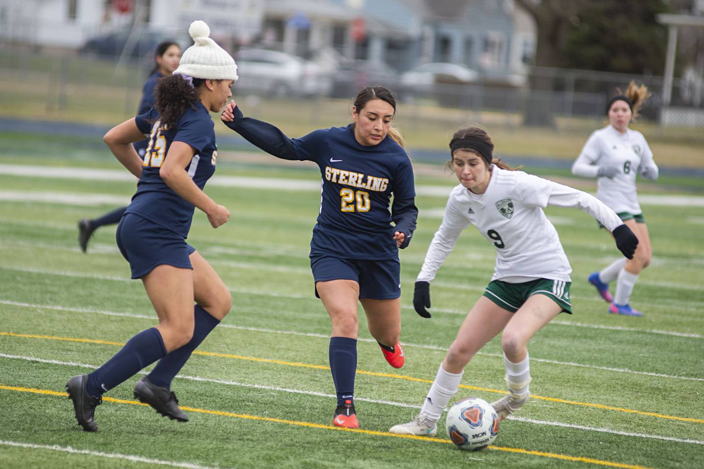 Sterling's Olivia Turner (left) and Ximena Aguilar work against Alleman's Abby Glackin Tuesday, March 29, 2022.