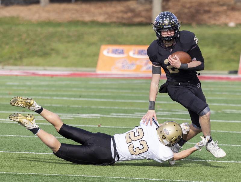 Lena-Winslow's Lucas Fye gets by Camp Point's Drew Paben for big yards Friday, Nov. 24, 2023 in the 1A state football championship game at Hancock Stadium in Normal.