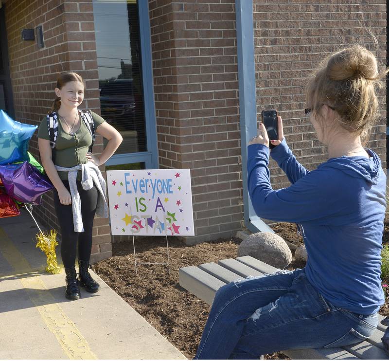 Capturing the moment of the first day of school, Cassandra Johnson takes a picture of her daughter Mylee Graham on Wednesday, Aug. 17, 2022, outside of Centennial School in Streator.