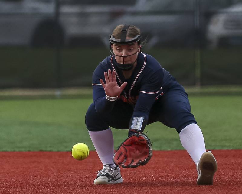 Oswego's Leah McKenzie (18) looks the ball into her glove before it took a bad hop resulting in an error during softball game between Oswego at Yorkville. May 5, 2026 in Yorkville.