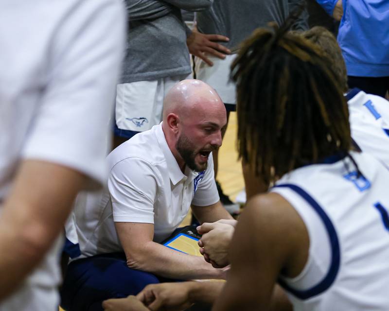 Downers Grove South's head coach Zach Miller instructs the team during basketball game between Hinsdale South at Downers Grove South. Dec 1, 2023.