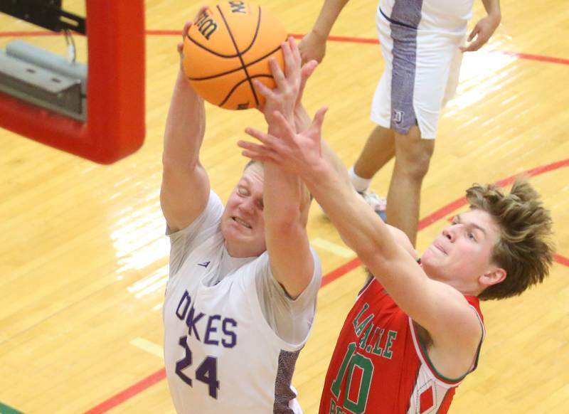 Dixon's Jakob Nicklaus grabs a rebound over L-P's Braylin Bond during the Class 3A Regional semifinal game on Wednesday, Feb. 26, 2025 in Sellett Gymnasium at L-P High School.
