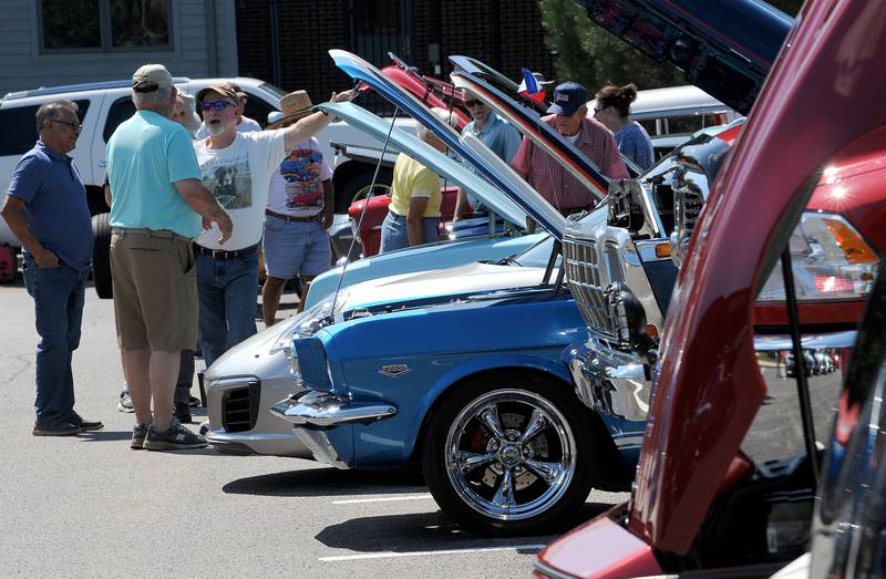 Car owners and fans checkout all the cars on display at the Dempsey Pride & Joy Car Show at Hometown Days on Sunday, Sept. 1, 2024, at Beecher Park in Yorkville.
