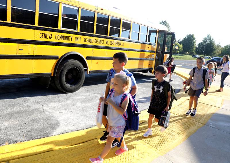 Students get off the bus for the first day of school at Heartland Elementary School in Geneva on Wednesday, Aug. 17, 2022.