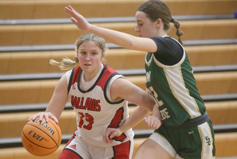 Henry-Senachwine's Grace Anderson dribbles around St. Bede's Quinn McClain on Thursday, Jan. 30, 2025 at Henry-Senachwine High School.