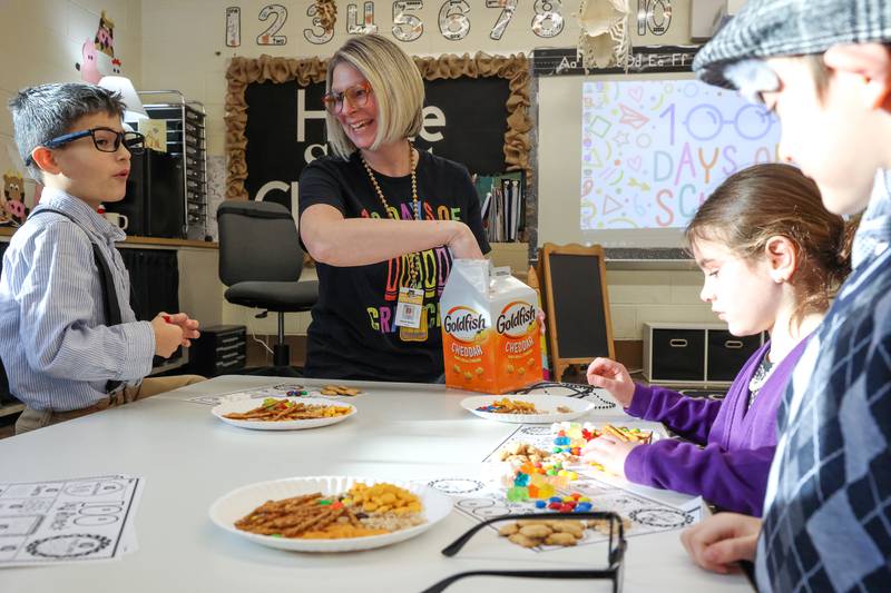 Shabbona Elementary School kindergarten teacher Randi Martin, center, passes out snacks for an activity during the 100th day of school on Monday, Feb. 9, 2026.