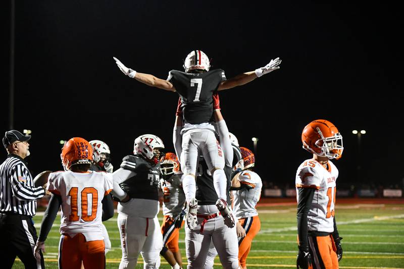 Bradley-Bourbonnais' Isaac Allison (7) is lifted in the air by his teammate, offensive lineman Jaedin Timms, after running in a touchdown Friday night during the Boilermakers' 42-0 victory over Whitney Young to advance to the quarterfinals.