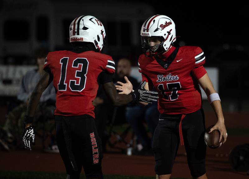 Bradley-Bourbonnais' Ellis Johnson, right, celebrates his touchdown in the 2nd quarter with teammate LyZale Edmon, left, in a game against T.F. North on Friday, August 29, 2025.