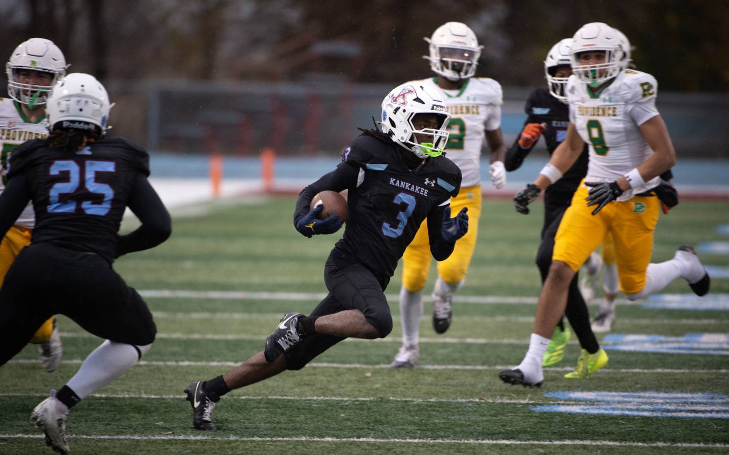 Kankakee's Cedric Terrell carries the ball after an interception in the first half of a Class 5A playoff against Providence Catholic on Saturday, November 8, 2025.