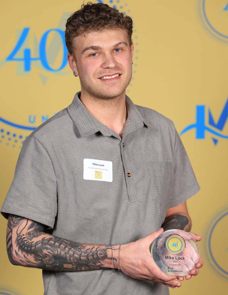 Mike Lock poses with his 40 Under Forty award during the Illinois Valley Chamber of Commerce Champions of Change Awards Night on Thursday, April 10, 2025 at the Westclox Event Center in Peru.