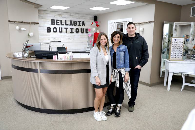 Mike and Gabby Plachetka are the new owners of Bella-gia, a contemporary women's clothing boutique, and The Prom Shoppe in downtown Oswego. They acquired the stores from longtime owners the Kaleel family, who opened American Male in 1977. Stacy Shaw, far left, is the buyer and store manager for both stores.