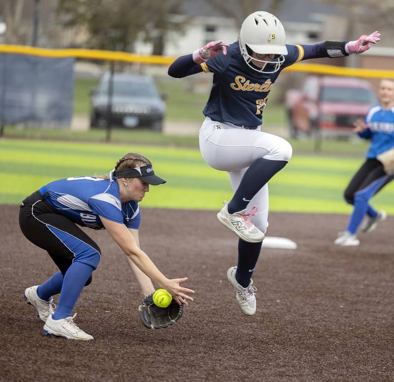 Sterling’s Kennedy Tate leaps over a grounder played by Quincy’s Ava Geisendorfer Tuesday, March 31, 2026.