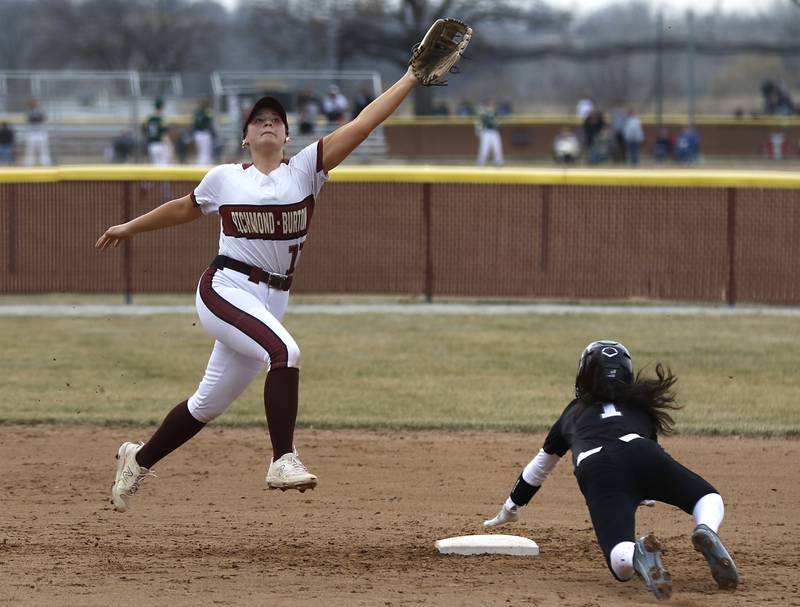 Richmond-Burton’s Gabby Hird tries to track down a high throw as Prairie Ridge's Kylie Rosene slides into second base during a nonconference softball game on Tuesday, March 18, 2025, at Richmond-Burton High School.