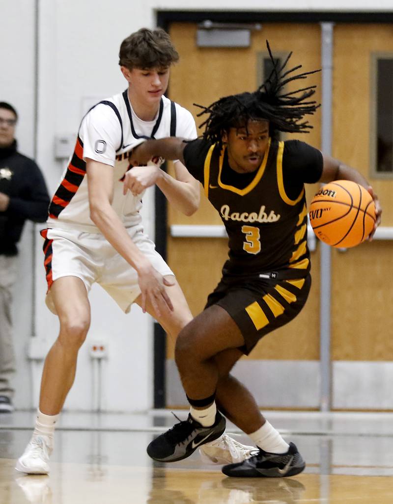 Jacobs' Emaan Thomas (left) steals the ball from McHenry's Blake Renfro during an IHSA Class 4A McHenry Regional basketball game on Wednesday, Feb. 26, 2025, at McHenry High School.