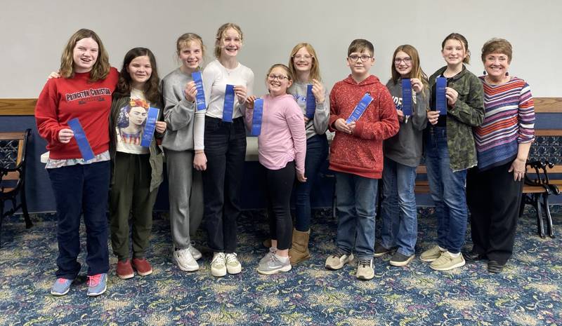 Princeton Christian Academy Speech Team claimed all first place ribbons at the recent Bureau Valley Elementary Conference Contest held at PCA.  The team includes (from left to right) Myla McCoy and Bella van den Berg performing a duet “Pullin’ the Wool,” Alice Scruggs and Karly Schultz performing a duet “What a Team,” Noelle Richey and Violet Scruggs in a duet “Super Duper Computer Store,” Fritz Anderson in a solo “The True Story of the Three Little Pigs,” Elise and Leah House in a duet “Surgery,” and coach Marty Kiser.