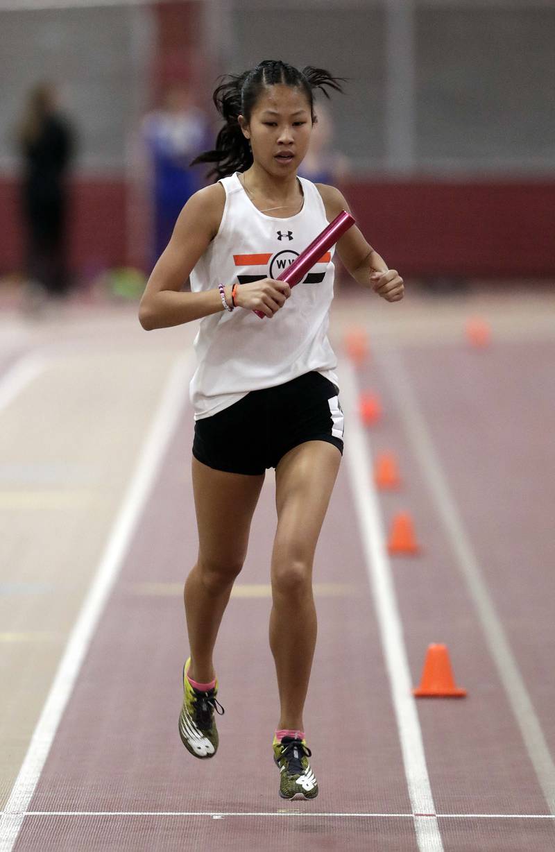 Wheaton Warrenville South’s Kim Matthershed in the 4x800 during the DuKane Girls Indoor Championship track meet Friday March 18, 2022 in Batavia.