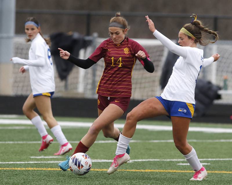 Johnsburg's Lauren McQuiston (right) pass the ball as Richmond-Burton's Josie Franckowiak pressures McQuiston during a Kishwaukee River Conference soccer game on Tuesday, April 1, 2025, at Richmond-Burton High School.