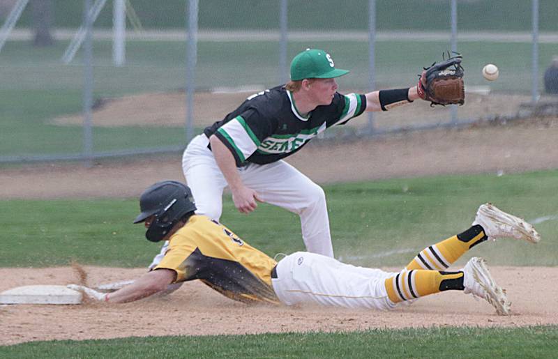 Putnam County's Andrew Pyszka (2) slides safely into third base as Seneca's Noah Quigley (14) catches a late throw on Tuesday, April 12, 2022 in Granville.