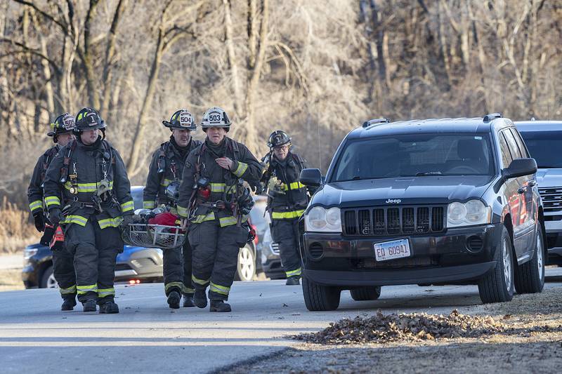 Firefighters bring in equipment Sunday, Jan. 19, 2025, while responding to a fire in Emerson.