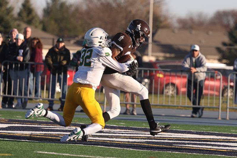 Joliet Catholic’s Adrain Washington drags the Providence defender on a touchdown catch in the Class 5A semifinal on Saturday, Nov. 18, 2023, in Joliet.