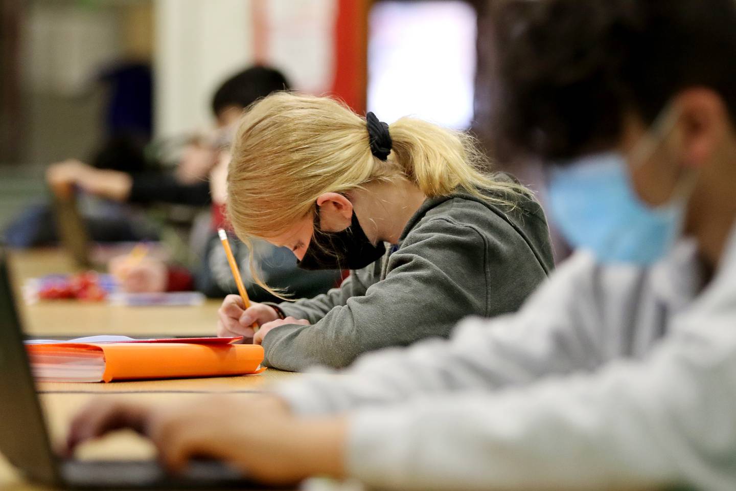 Madison Grindle, center, and Julian Vargas, both 8th grade students at Marengo Community Middle School, work in a homework help after school program at the school on Wednesday, March 24, 2021 in Marengo.