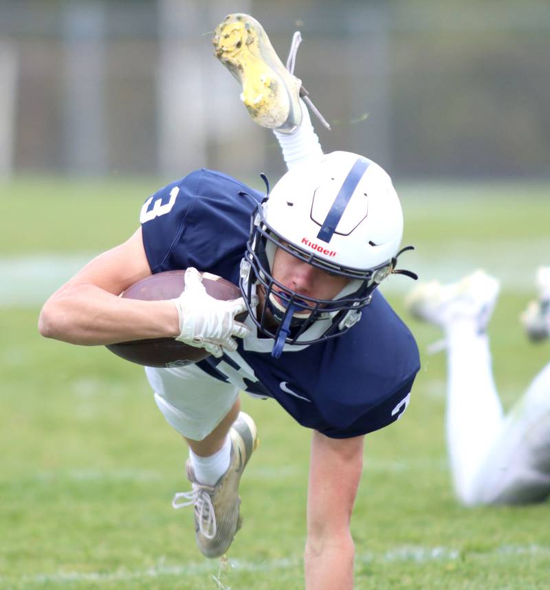 Cary-Grove’s Ty Tenopir gets tripped up on a late run against Sycamore in IHSA football Class 5A first-round playoff action at Al Bohrer Field on the campus of Cary-Grove High School in Cary on Saturday, November 1, 2025.