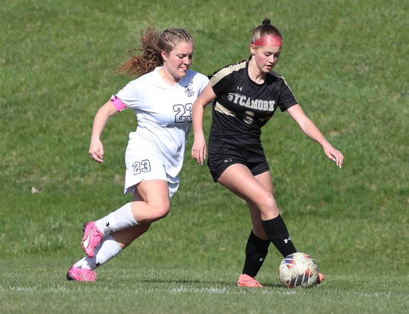 Sycamore's Marin Gautcher tries to hold off Kaneland's Lindsey Stoddard during their game Monday, April 14, 2025, at Sycamore High School.