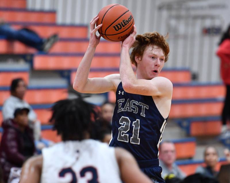 Oswego East's Andrew Pohlman (21) starts a jump pass during a Hoops for Healing tournament game against West Aurora on Nov. 20, 2023 at Naperville North High School in Naperville.